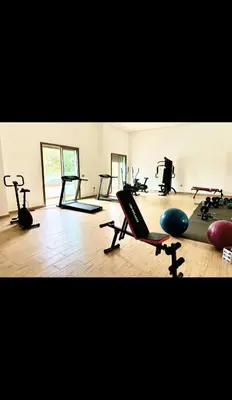 a gym with many exercise equipment in a room at Garden paradis bouznika in Bouznika