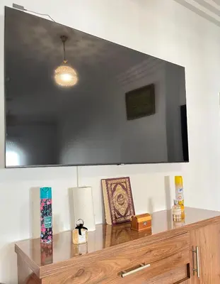 a large flat screen tv hanging on a wall at Zenata Family Apartment in Aïn Harrouda