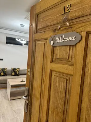 a wooden door with a welcome sign on it at Confort et mer Océan Rabat in Rabat