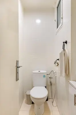 a white bathroom with a toilet and a sink at Authentic & Spacious 2 Bedrooms Heart of Rabat in Rabat