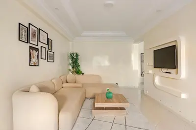 a living room with a couch and a tv at Authentic & Spacious 2 Bedrooms Heart of Rabat in Rabat