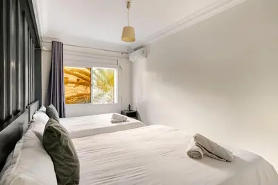 a bedroom with two beds and a window at Authentic & Spacious 2 Bedrooms Heart of Rabat in Rabat