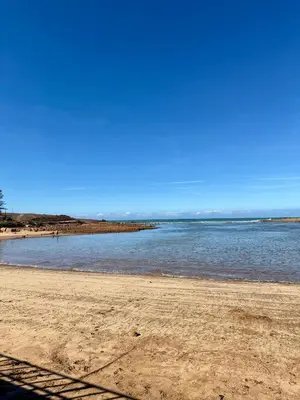 a beach with the ocean on a clear day at Charmante maison de vacances proche de la plage à quelques minutes de Rabat in Temara