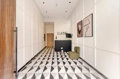a hallway with a black and white checkered floor at Appartement Design avec Parking et Salle de Sport Ferme Bretonne in Casablanca