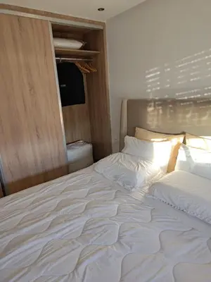 a large white bed sitting in a room at 2 min walk from Four Seasons Hotel-Cozy Terrace Stay in the Heart of Rabat in Rabat
