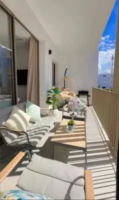 a living room with couches and tables on a balcony at A Wonderful Escape In Morocco in Casablanca