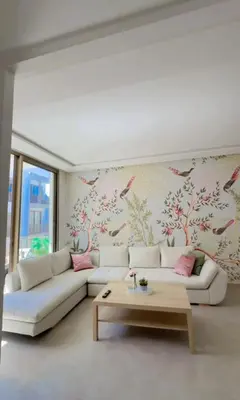 a living room with a white couch and bird wallpaper at A Wonderful Escape In Morocco in Casablanca
