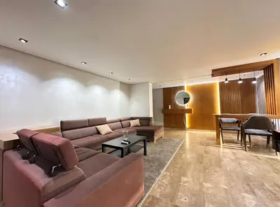 a living room with a couch and a table at RDJ 2CH haut standing - Bouskoura in Bouskoura
