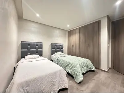 two beds sitting next to each other in a bedroom at RDJ 2CH haut standing - Bouskoura in Bouskoura