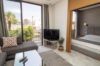 a living room with a couch and a bed and a tv at B5 Modern bright studio with city view in Casablanca
