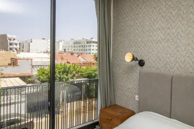 a bedroom with a balcony with a view of a city at B5 Modern bright studio with city view in Casablanca