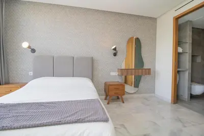 a bedroom with a bed and a bathroom with a tub at B5 Modern bright studio with city view in Casablanca