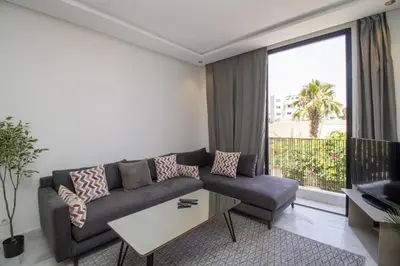 a living room with a couch and a large window at B5 Modern bright studio with city view in Casablanca