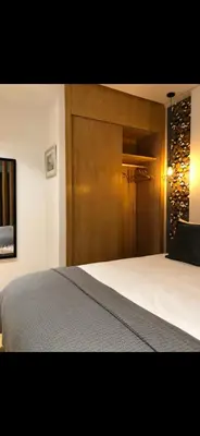 a bedroom with a large bed with a wooden headboard at Studio lumineux et cosy in Casablanca