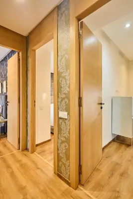 a hallway with wooden doors and a screen at Terrasses and Sunset Duplex Luxe 3 Bed in Ghandi in Casablanca