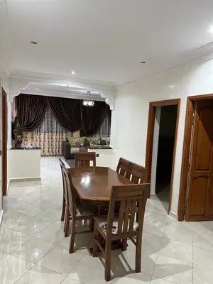 a dining room with a wooden table and chairs at 3-Bedroom Apartment - Rabat - 2Baths & 2Balconies in Rabat