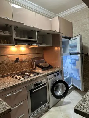 a kitchen with a washing machine and a refrigerator at 3-Bedroom Apartment - Rabat - 2Baths & 2Balconies in Rabat
