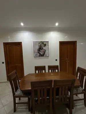 a dining room with a wooden table and chairs at 3-Bedroom Apartment - Rabat - 2Baths & 2Balconies in Rabat