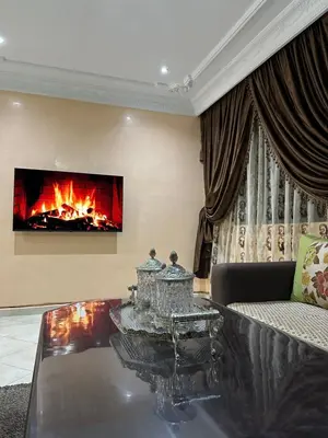 a living room with a couch and a fireplace at 3-Bedroom Apartment - Rabat - 2Baths & 2Balconies in Rabat
