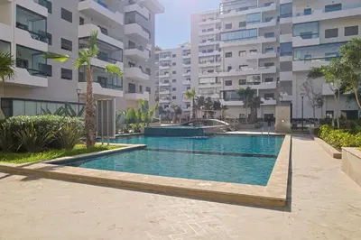 a swimming pool in the middle of a building at Studio Cosy avec Piscine & proche de la plage in Aïn Harrouda