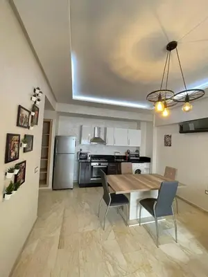a kitchen with a wooden table and a dining room at Mohemmadia in Mohammedia