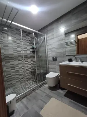 a bathroom with a shower and a toilet and a sink at Mohemmadia in Mohammedia