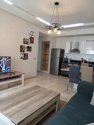 a living room with a couch and a table at Mohemmadia in Mohammedia