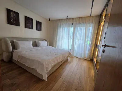 a bedroom with a bed and a large window at Luxury 1 bedroom at La marina in Casablanca