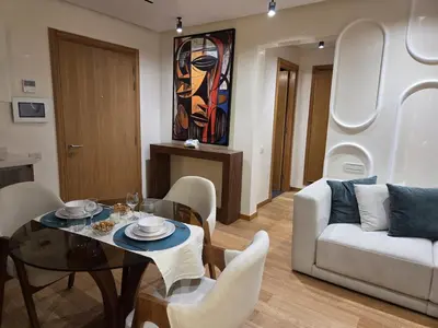 a living room with a table and a couch at Luxury 1 bedroom at La marina in Casablanca
