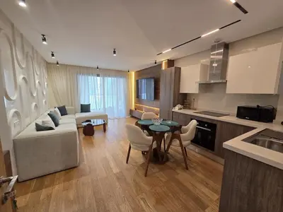 a kitchen and living room with a couch and a table at Luxury 1 bedroom at La marina in Casablanca