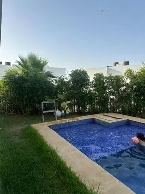 a small swimming pool in a yard with a building at A beautiful luxury villa in Rabat in Aïn el Apuda