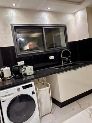 a kitchen with a washing machine and a sink at Appartement neuf vue mer sur la corniche in Rabat