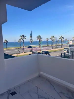 a room with a view of the beach and the ocean at Appartement neuf vue mer sur la corniche in Rabat