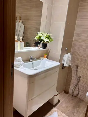 a bathroom with a white sink and a mirror at Appartement neuf vue mer sur la corniche in Rabat