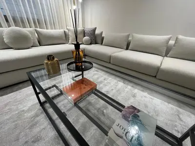 a living room with a couch and a glass table at Studio a 2 pas des TWINS CENTER boulevard Massira Khadra in Casablanca