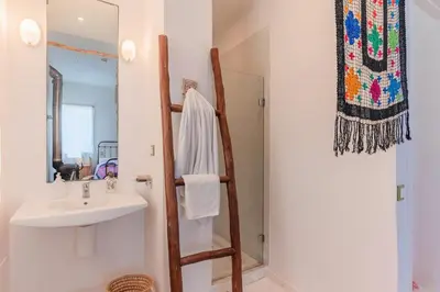 a bathroom with a sink and a mirror at Cabanon Rêve Bleu terrace and infinite horizon in O Ben Slimane