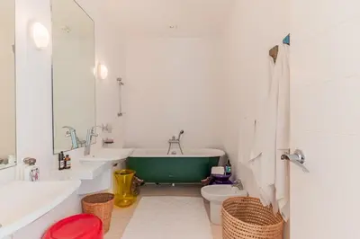 a bathroom with a tub and a toilet and a sink at Cabanon Rêve Bleu terrace and infinite horizon in O Ben Slimane