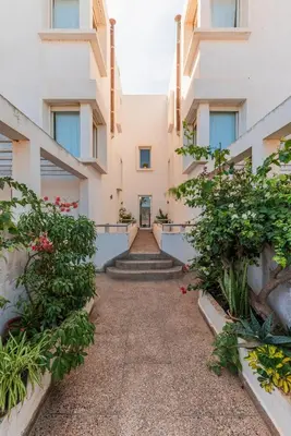 a corridor of a building with plants and stairs at Cabanon Rêve Bleu terrace and infinite horizon in O Ben Slimane