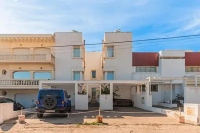a house with a blue truck parked in front of it at Cabanon Rêve Bleu terrace and infinite horizon in O Ben Slimane