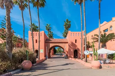 an archway in a building with palm trees at Cabanon Rêve Bleu terrace and infinite horizon in O Ben Slimane