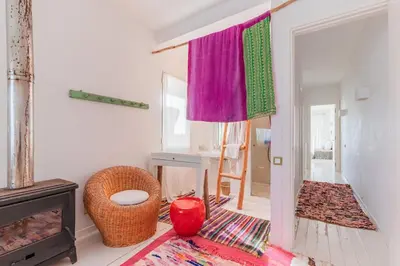 a living room with a fireplace and a window at Cabanon Rêve Bleu terrace and infinite horizon in O Ben Slimane