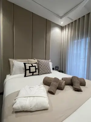 a bedroom with a large white bed with pillows at Studio Chic proche Twins Center in Casablanca