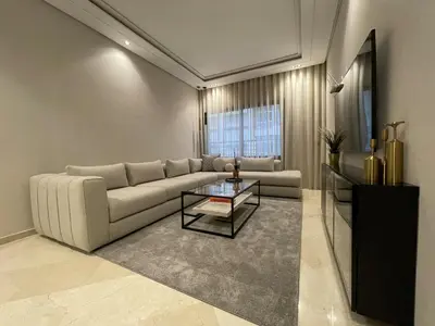 a living room with a couch and a table at Studio Chic proche Twins Center in Casablanca