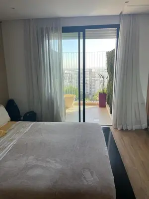 a bedroom with a large bed and a large window at Prestigia Luxurious 3BR 5 min walk from stadium in Rabat