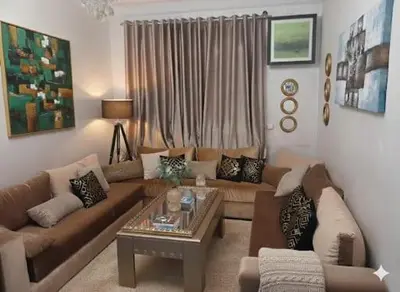 a living room with a couch and a coffee table at Appartement dans le centre de la plage de av Tantan in Casablanca