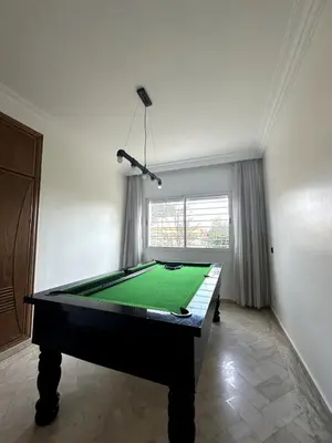 a pool table in a room with a green cloth at La Perle Aïn Diab Beachfront in Casablanca