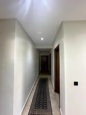 an empty hallway with a rug on the floor at La Perle Aïn Diab Beachfront in Casablanca