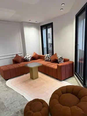 a living room with two brown couches and a table at 2 bedrooms in the heart of Casablanca in Casablanca