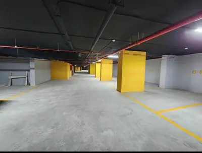 an empty parking lot with yellow columns in a parking garage at 2 bedrooms in the heart of Casablanca in Casablanca