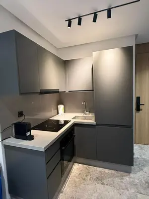 a kitchen with gray cabinets and a sink at 2 bedrooms in the heart of Casablanca in Casablanca